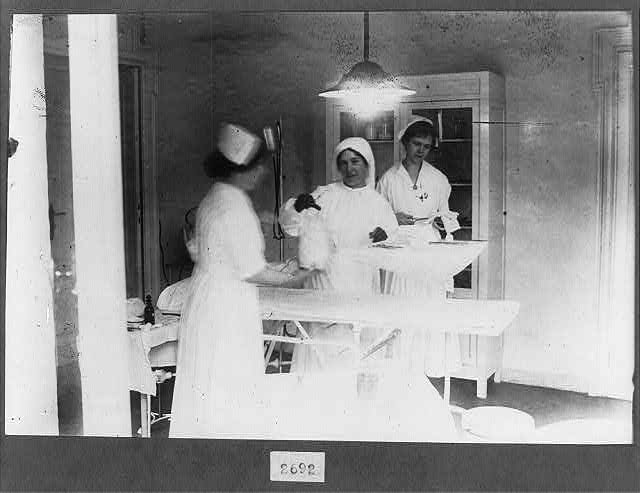 Agnes von Kurowsky with two other nurses in an operating room, Red Cross Hospital, Milan, during World War I