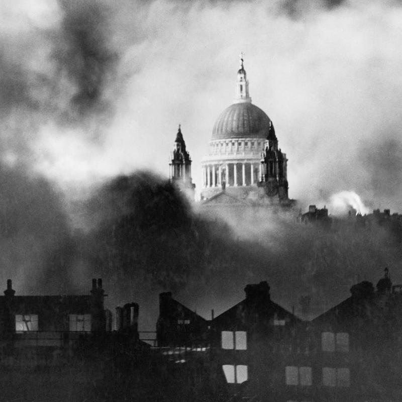 Standing out of the flames and smoke of surrounding blazing buildings, St Paul's Cathedral during the great fire raid in London, December 29-30, 1940.