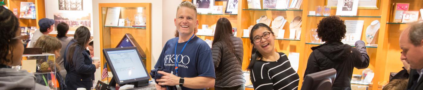 Library staff help in the museum store during the JFK 100 celebration
