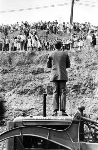 JFK speaks to a crowd from atop a tractor